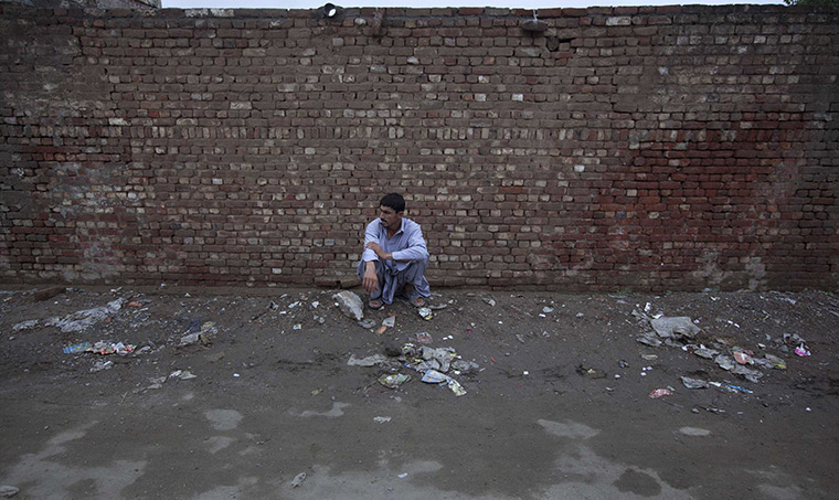 FTA: Adrees Latif   : Ikramullah, 38, sits in front of the same brick wall, almost a year later