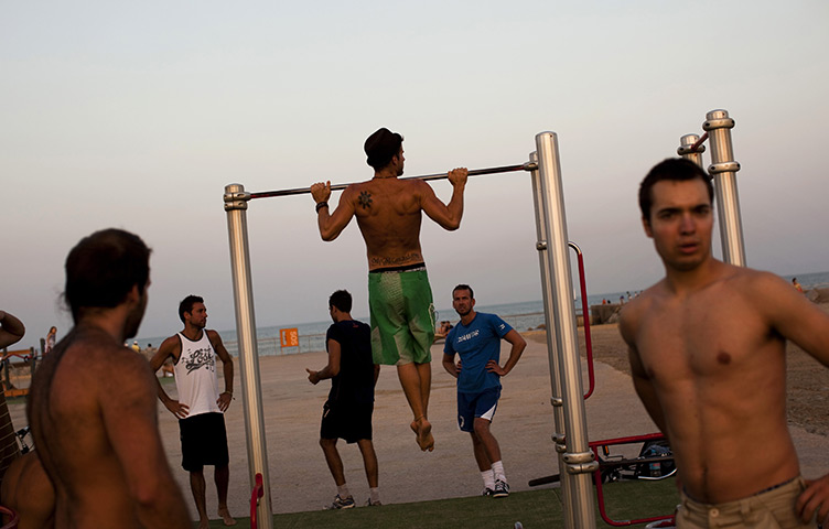 24 hours in pictures: Men exercise in a public park near the beach in Barcelona, Spain