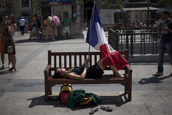 24 Hours: A pilgrim holds a French flag as Pope Benedict XVI visited Spain
