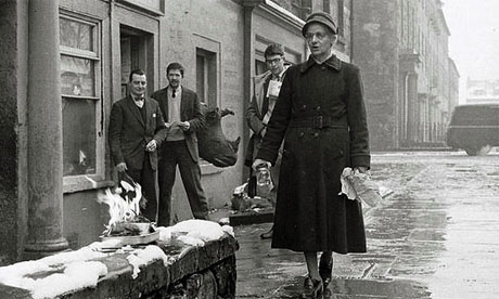 Jim Haynes, second left, watches the book burning outside his shop