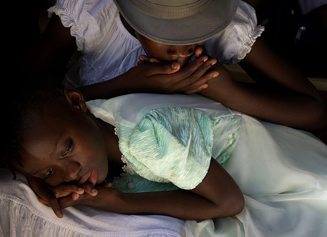 24 hours in pictures: Port-au-Prince, Haiti: Girls rest during a gathering of schools 