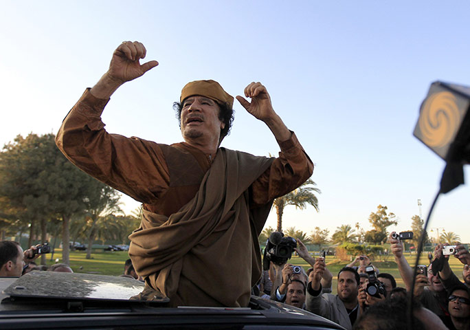 Gaddafi: 10 April 2011: Libyan leader Muammar Gaddafi cheers his supporters