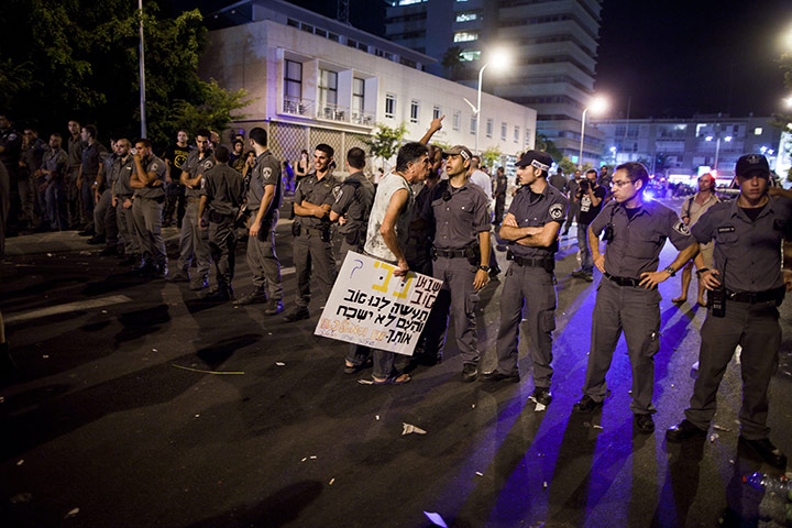 FTA: Oded Balilty: Israeli police officers line up in front of a protester at the end of rally