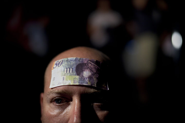 FTA: Oded Balilty: An Israeli man with a bill attached to his forehead at a protest