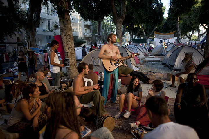 FTA: Oded Balilty: Israeli protesters play music in a protest tent encampment 