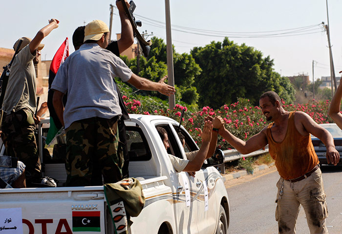 Libya update: Local residents greet advancing rebel fighters on the outskirts of Tripoli