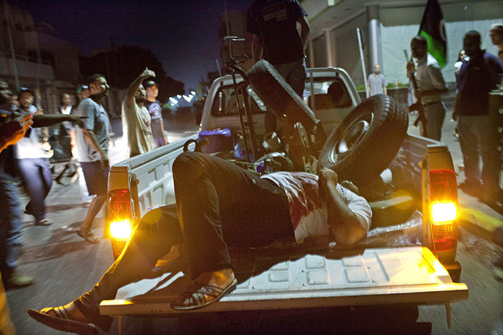 Battle for Tripoli: A man wounded by a sniper comes to a rebel makeshift checkpoint 