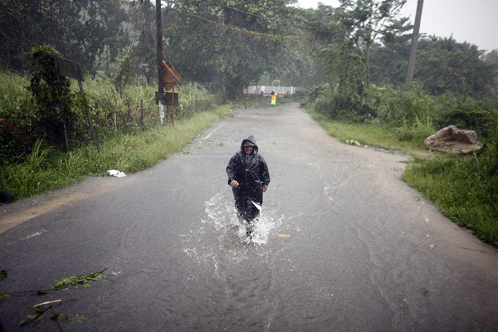 Hurricane Irene: A man wades through a flooded street in Naguabo, Puerto Rico