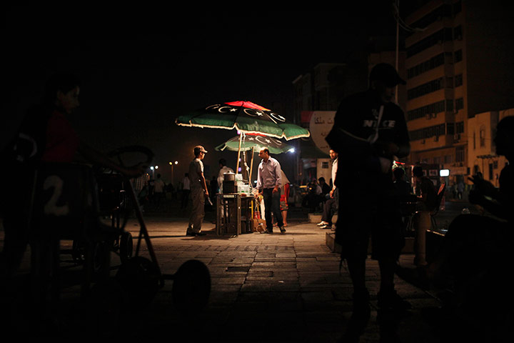 24 hours in pictures: People sell food on the street, Benghazi, Libya