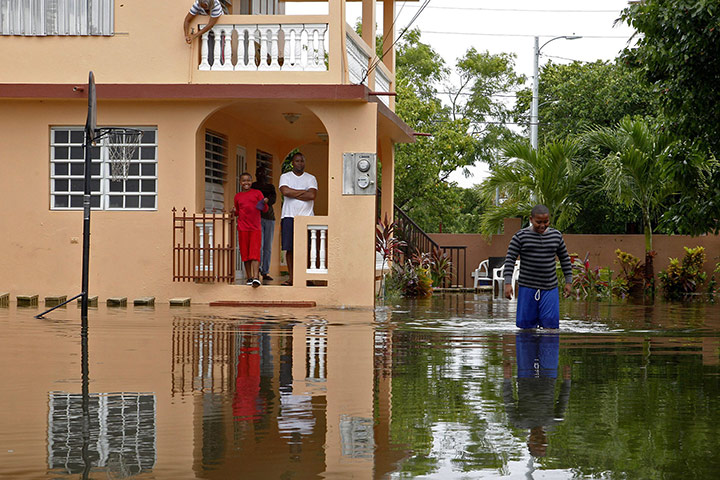 Hurricane Irene: A boy walks in a flooded road after Hurricane Irene hit Loiza, Puerto Rico.