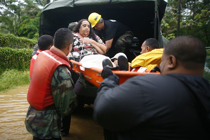 Hurricane Irene: A woman is carried on a stretcher by civil defence workers