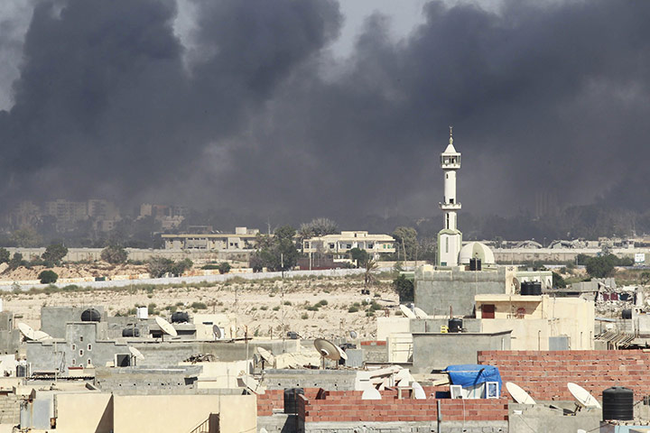 Battle for Tripoli: Smoke rises above downtown Tripoli at the Bab Al-Aziziya compound 