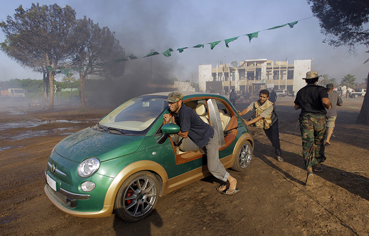 Gaddafi's compound falls: Rebel push the car inside the main compound 