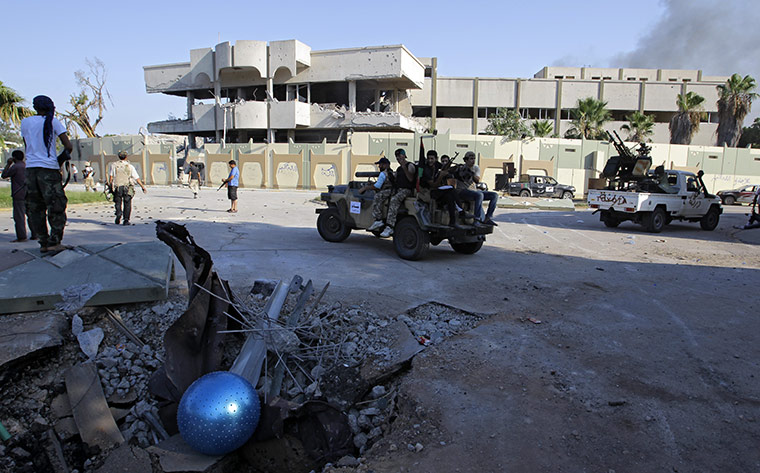 Gaddafi's compound falls: Rebel cars inside the main compound after it was stormed 