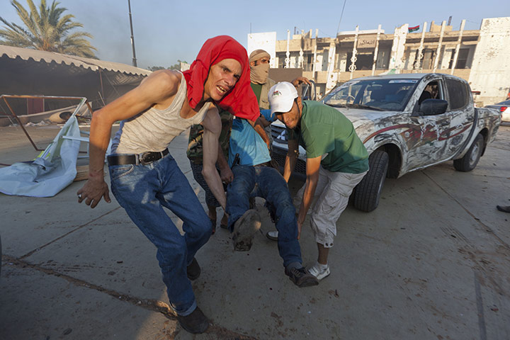 Gaddafi's compound falls: An injured fighter in the compound