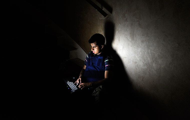 Media in Rixos hotel: Journalist works on a staircase during a power cut, Rixos Hotel, Tripoli