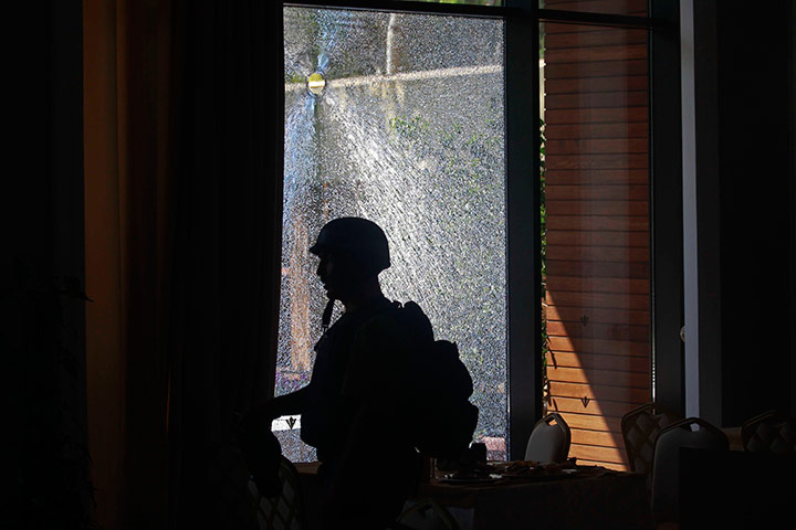 Media in Rixos hotel: Media walk past shattered window, Rixos Hotel, Tripoli