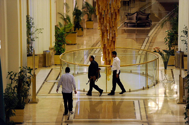Media in Rixos hotel: An armed man loyal to Muammar Gaddafi walks through the Rixos hotel