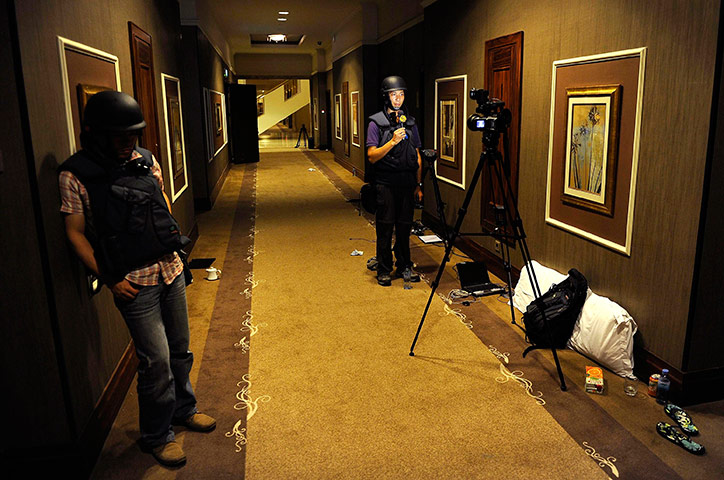 Media in Rixos hotel: A television reporter speaks during a recording, Rixos Hotel, Tripoli