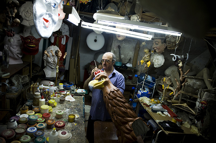 24 hours: Barcelona, Spain: Agustin paints a papier mache giant mask