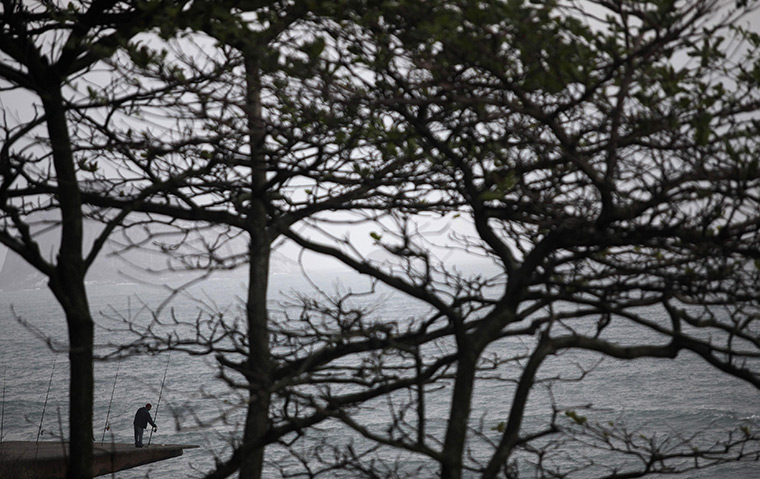 24 hours: Sao Conrado, Brazil: A fisherman checks his equipment