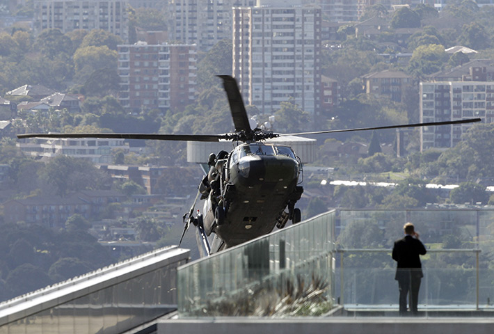 24 hours: Sydney, Australia: A man watches an Australian Army Blackhawk helicopter