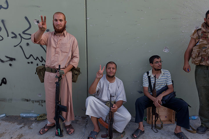 Sean Smith in Tripoli: Rebel forces gesture after storming Gaddifi's compound 