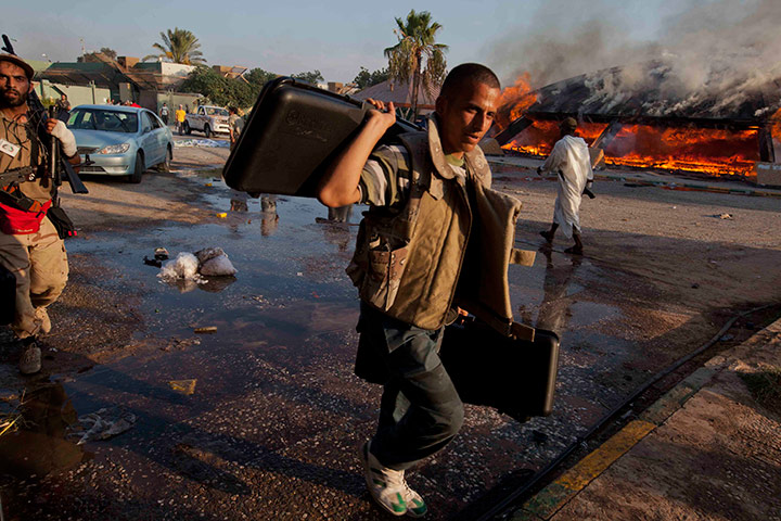 Sean Smith in Tripoli: Rebel fighter with looted goods, Bab Al-Aziziya, Tripoli