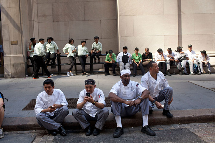 US earthquake: Restaurant workers wait on Wall Street in New York