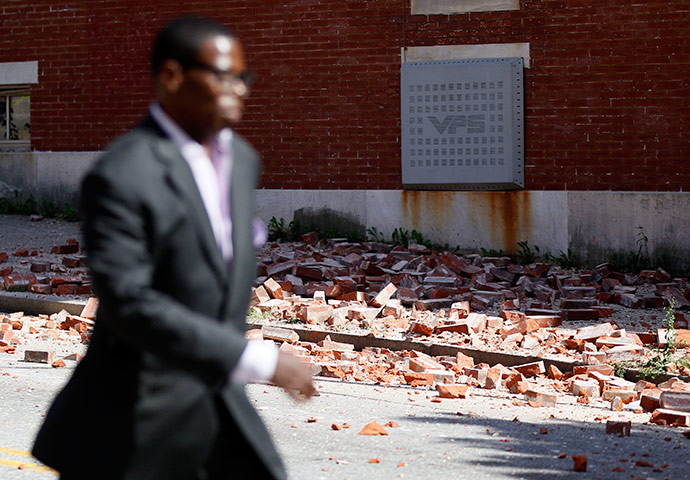 US earthquake: A man walks past bricks that fell off of a house in Baltimore