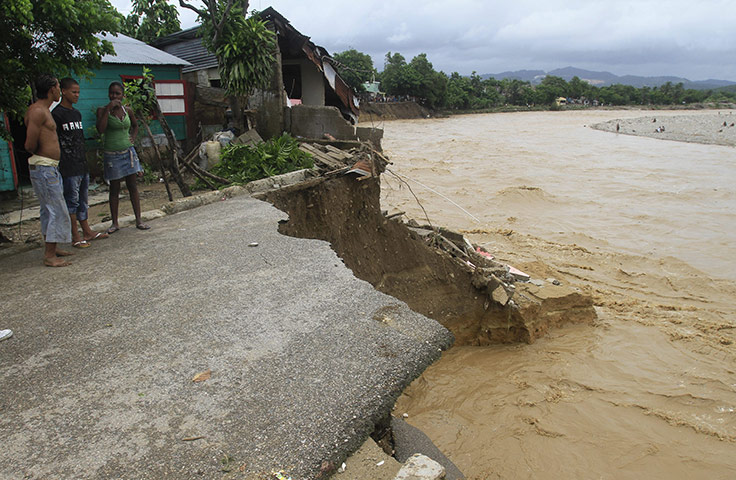 Hurricane Irene: Residents look at a road destroyed by the overflow of the Nigua River