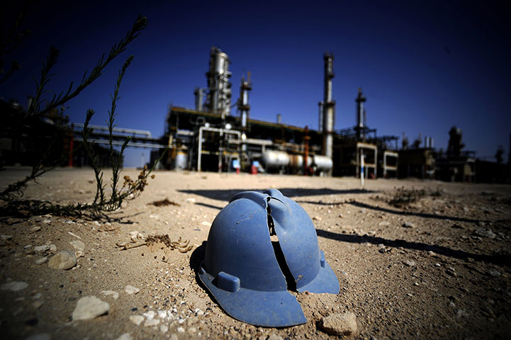Week in Business: A worker's helmet lies on the ground at the Zawiya oil refinery, Libya
