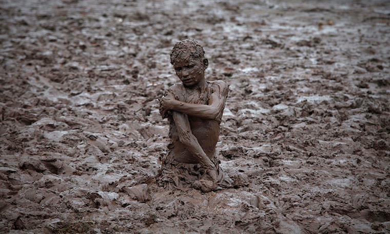 24 hours in pictures: A boy plays in the mud near the Ravi, Pakistan