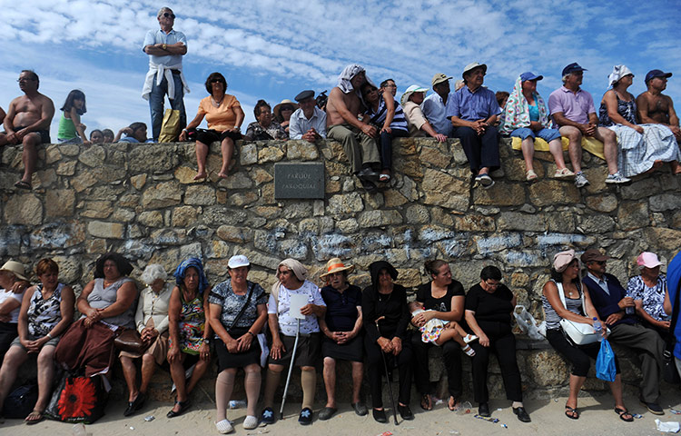 24 hours in pictures: Revelers wait for St. Bartholomew's procession, Portugal