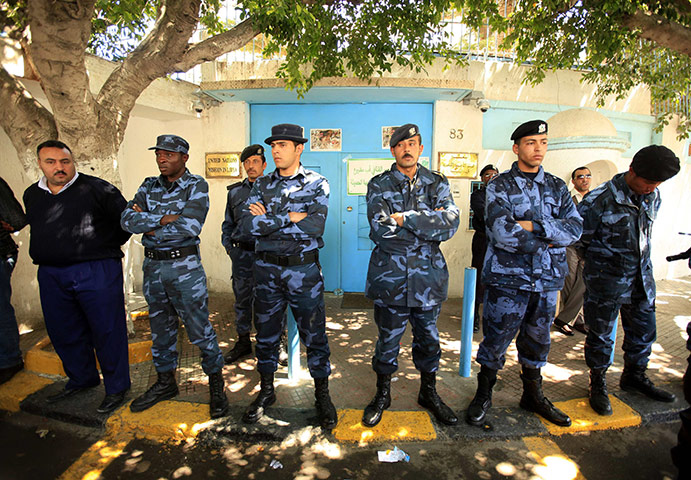 Week in Business: Libyan policemen stand guard at UN office in Tripoli in April 