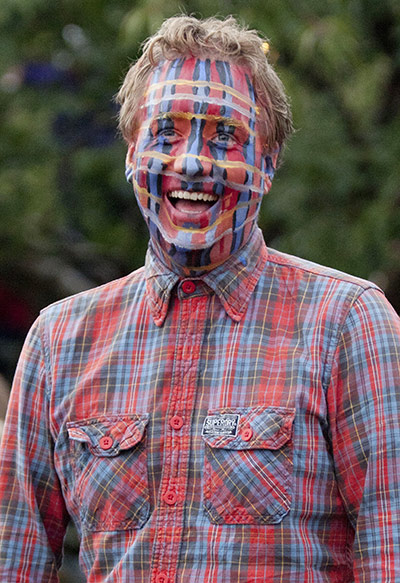 Green Man Festival: A festivalgoer's face painted with checks