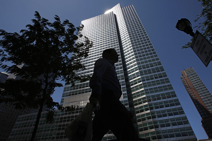 Week in Business: A pedestrian passes the headquarters of Goldman Sachs Group in New York