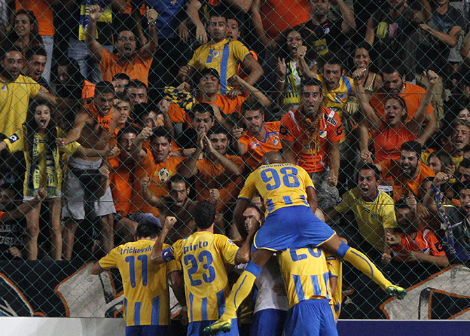 Champions League Draw: APOEL players celebrate scoring a goal against Wisla Krakow