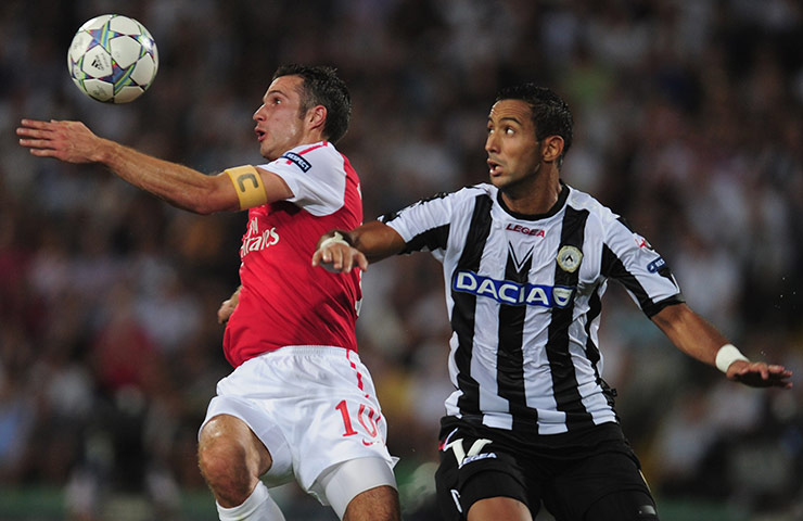Champions League Draw: Robin van Persie of Arsenal battles with Medhi Benatia of Udinese 
