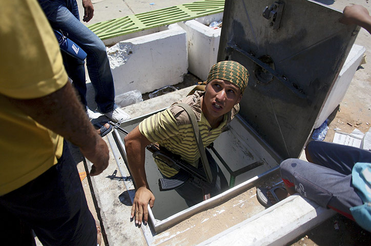 Bab al-Aziziya, Tripoli: A Libyan rebel enters a tunnel, Bab al-Aziziya compound