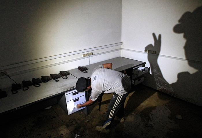 Bab al-Aziziya, Tripoli: Rebel fighters search a communication room in the bunker, Bab al-Aziziya