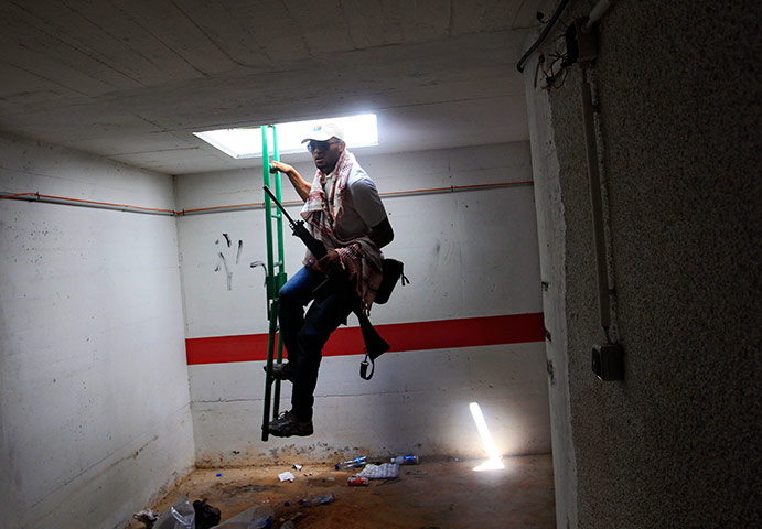 Bab al-Aziziya, Tripoli: A rebel fighter enters a bunker, Bab al-Aziziya compound