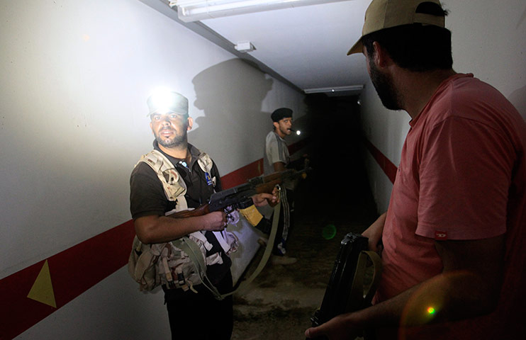 Bab al-Aziziya, Tripoli: Rebel fighters inspect a tunnel in the bunker, Bab al-Aziziya compound