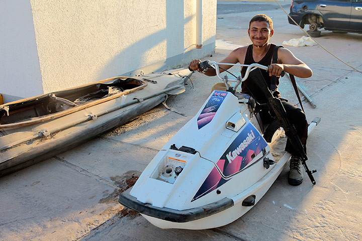 Bab al-Aziziya, Tripoli: A rebel pretends to drive a jet ski, Bab al-Aziziya, Tripoli