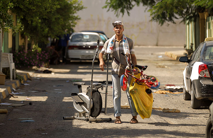 Bab al-Aziziya, Tripoli: A rebel loots leisure equipment, Bab al-Aziziya, Tripoli