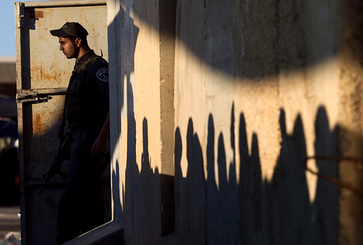 24 hours in pictures: An Israeli border policeman at Israel's Qalandiya checkpoin
