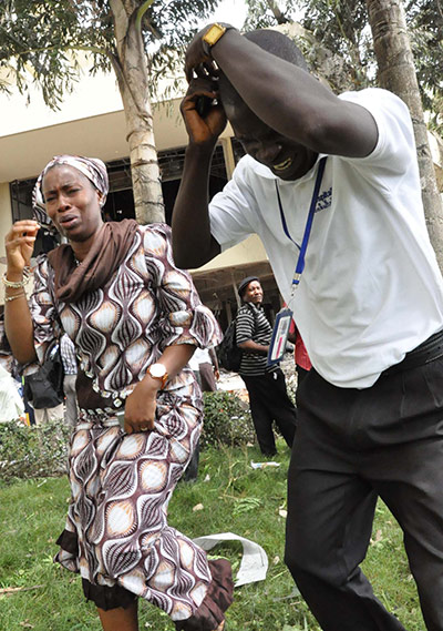 UN Abuja bomb blast: Employees of the United Nations building react after the blast