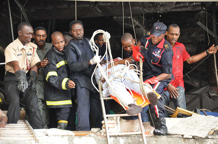 UN Abuja bomb blast: An injured man is evacuated after an explosion in UN building