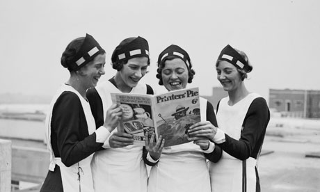 Four women reading 'Printers' Pie' magazine