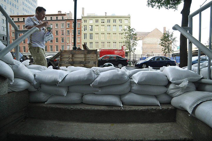 Irene Hurricane: A pedestrian passes next to sandbags in downtown Manhattan in New York